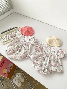 Macro shot of floral baby romper featuring lace trim collar and retro flower print fabric