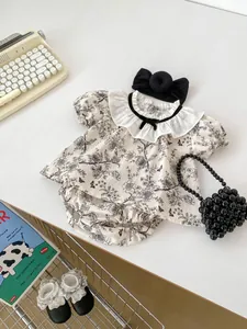 Flat lay of baby girl vintage floral set with ruffled collar top and matching bloomers