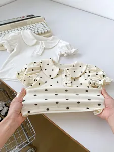 Detail showing the high elastic cotton fabric of baby t-shirts with Peter Pan collar design