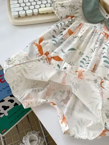 Detail of snap button closure and deer print on cotton baby romper and bodysuit