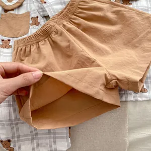 Detailed view of elastic waistband and soft cotton fabric on baby summer bear romper