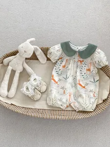 Detail of baby animal print romper with Peter Pan collar in a decorative woven basket