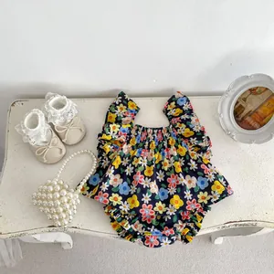 Flat lay of baby girl floral sleeveless top with ruffled details and matching shorts