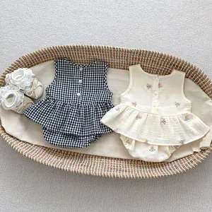 Detailed embroidery and back button closure on plaid and floral cotton baby sets