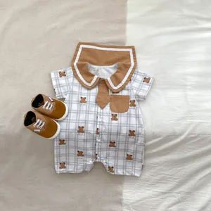 Detail of baby boys rompers with cute bear print, sailor collar and matching shoes