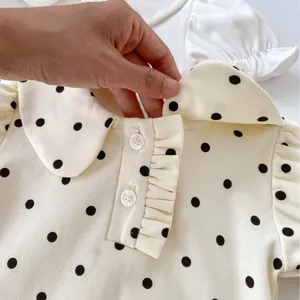 Short-sleeved baby cotton shirt with Peter Pan collar and black polka dot pattern