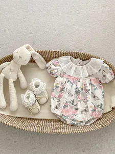 Floral baby bodysuit with lace trim and matching shoes in a woven bassinet
