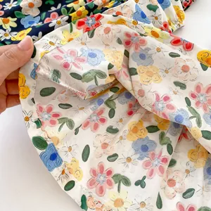 Detailed view of the colorful floral print fabric and high-quality stitching on baby clothes