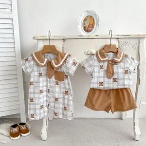 Detail of baby summer cotton romper with brown sailor collar and cute bear print pattern