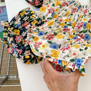 Detailed view of elastic waist and leg cuffs on floral cotton baby bloomers shorts