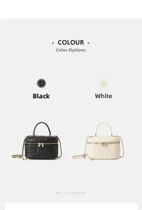 Detail of quilted leather mini box bags in black and white with gold chain straps