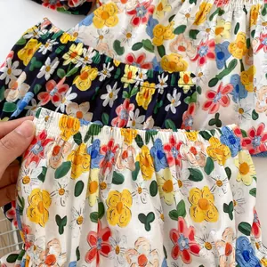 Detail of baby floral cotton shorts with elastic waistband in cream and navy blue colors