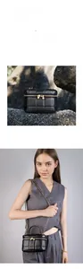 Detail of black quilted leather vanity bag with gold chain strap and dual zippers