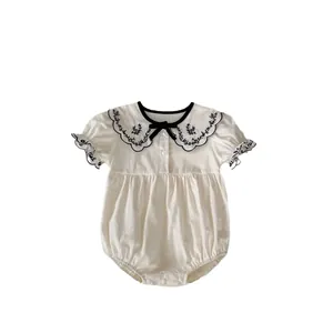 Infant short sleeve cotton romper with embroidered Peter Pan collar and black bow detail