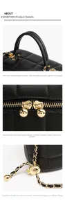 Detail of black quilted leather handbag with gold hardware and adjustable chain strap