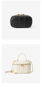 Close-up of quilted leather handbag with gold zippers and chain strap detail