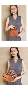 Detail view of brown genuine leather toiletry bag with interior elastic compartments
