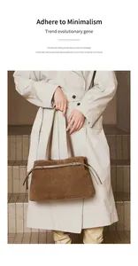 Minimalist brown suede leather tote bag featuring a metallic buckle strap detail