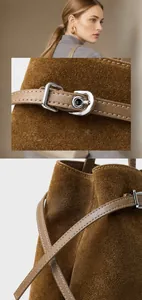 Close-up of brown suede leather tote with polished silver hardware and fine texture