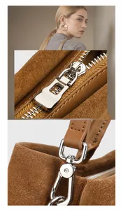Macro detail of high-shine silver metal zipper and hardware on brown suede leather tote bag