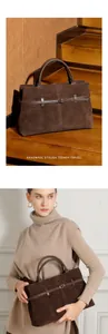 Detail of dark brown matte leather tote bag with metal buckle and decorative strap