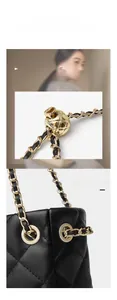Detail view of quilted leather bag featuring adjustable golden ball and metal chain strap
