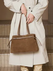 Brown suede leather tote bag with silver buckles and minimalist retro style for women
