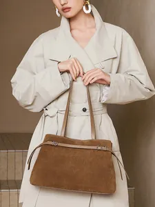 Brown vintage suede leather tote bag for women shown on a model wearing a beige trench coat
