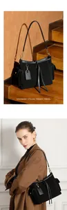 Dettaglio borsa tote in pelle scamosciata nera opaca con fibbie dorate e tasche laterali