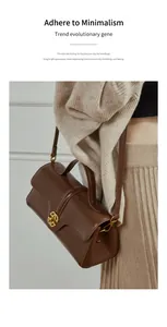Brown leather handbag with gold scallop clasp styled with a minimalist beige outfit
