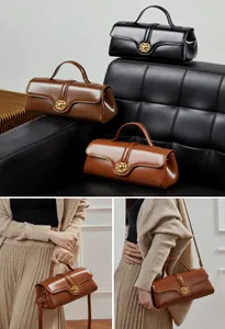 Detail of vintage leather handbag showing metal floral buckle and versatile strap options