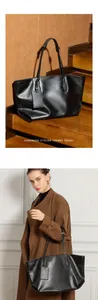 Close-up of a large black leather tote bag on stairs and shown worn by a model