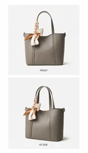 Detalle de bolso tote grande de cuero gris oscuro con textura y pañuelo de seda