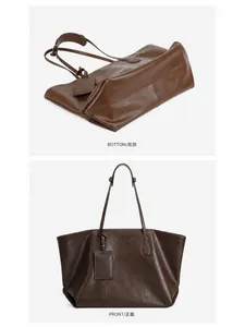 Detail view of the chocolate leather tote bag showing bottom seams and long strap
