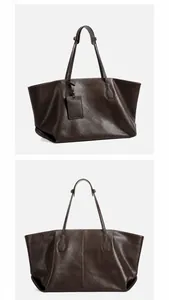 Detail view of large brown leather tote bag showing 45-degree side and back angles