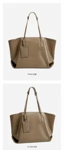 Detail view of large gray vegetable tanned leather tote bag with side and front angles