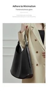 Detail of adjustable strap with silver buckle on minimalist black leather tote bag
