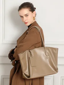 Taupe large capacity genuine leather tote bag with shoulder strap shown on model