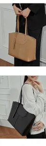 Close-up of premium leather tote bag detailing reinforced stitching and metal hardware
