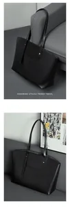Detail of premium black leather tote bag with fine stitching and silver metal buckle