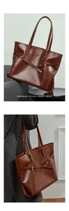 Detail of vintage brown leather tote bag showing adjustable metal buckle and fine texture