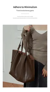 Detail view of large dark coffee tote bag with smooth leather and adjustable straps