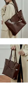 Detail of dark brown leather tote bag showing metal ring buckle and adjustable strap