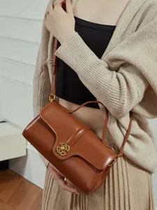 Retro brown leather handbag with gold metal clasp and adjustable shoulder strap