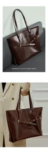 Close-up of a vintage dark brown leather tote bag with elegant gold buckle details