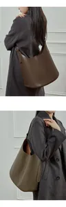 Detailed view of dark brown leather hobo bag with adjustable silver buckle strap