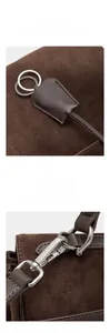 Detail of premium brown suede tote featuring silver metal ring charms and metal hooks