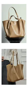 Close-up of a large beige tote bag with soft leather texture and adjustable shoulder strap