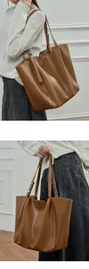 Detail of adjustable strap and large capacity brown faux leather tote bag for women