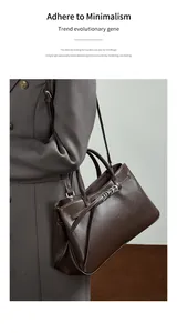 Détail du sac baguette en cuir marron foncé avec une boucle en métal argenté en éventail